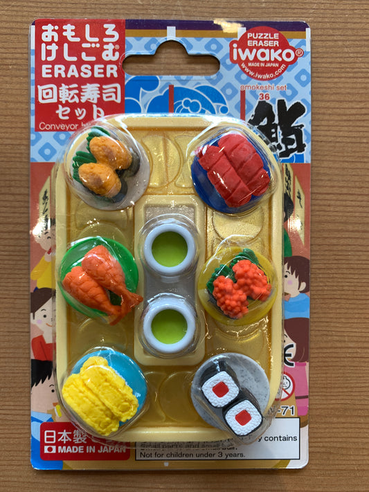 Colorful Japanese conveyor belt sushi eraser set with miniature sushi pieces and condiments, packaged for children 3+