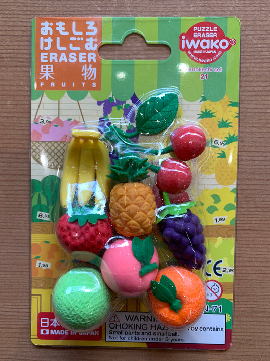 Colorful Iwako Japanese fruit-shaped erasers set, including banana, strawberry, pineapple, and grapes on vibrant packaging