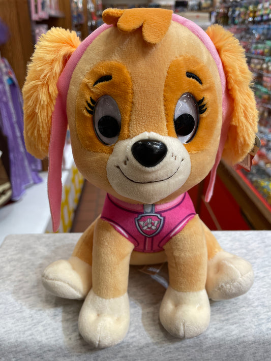 Gund Paw Patrol Skye plush toy, 9-inch, featuring a smiling Cockapoo in pink pilot uniform with goggles, sitting on display