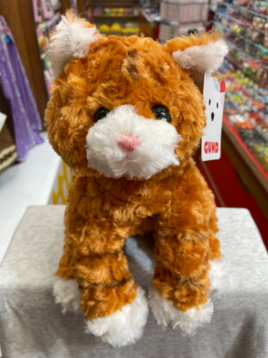 Gund Sienna orange tabby cat plush toy, 14 inches, soft and cuddly with white paws and face, displayed in toy store
