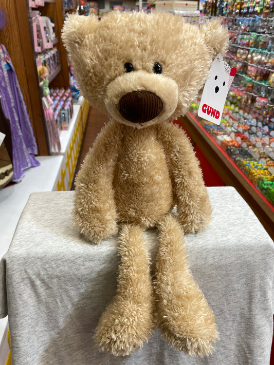 Gund Toothpick Bear plush toy, 15-inch soft beige teddy with long limbs and sweet expression, displayed in toy store