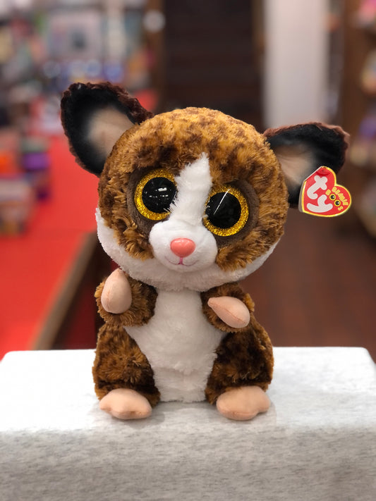 Ty Beanie Boo Binky bush baby plush with large golden eyes, brown fur, and white belly, sitting on display