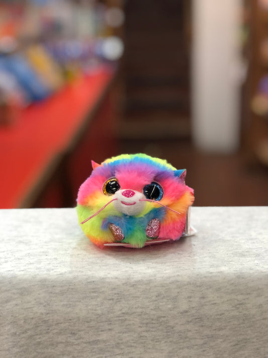 Ty Puffies Gizmo rainbow cat plush toy with big sparkly eyes, sitting on white surface, perfect for fun outdoor play