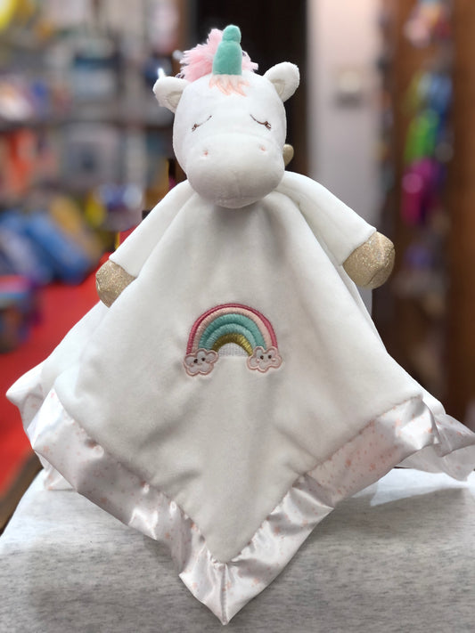 Soft white unicorn plush toy with pink mane, teal horn, gold hooves, and embroidered rainbow on blanket-style body