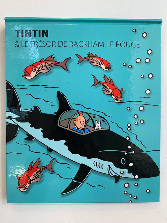 Tintin pop-up book cover showing underwater scene with shark-shaped submarine, red fish, and bubbles from "Red Rackham's Treasure"