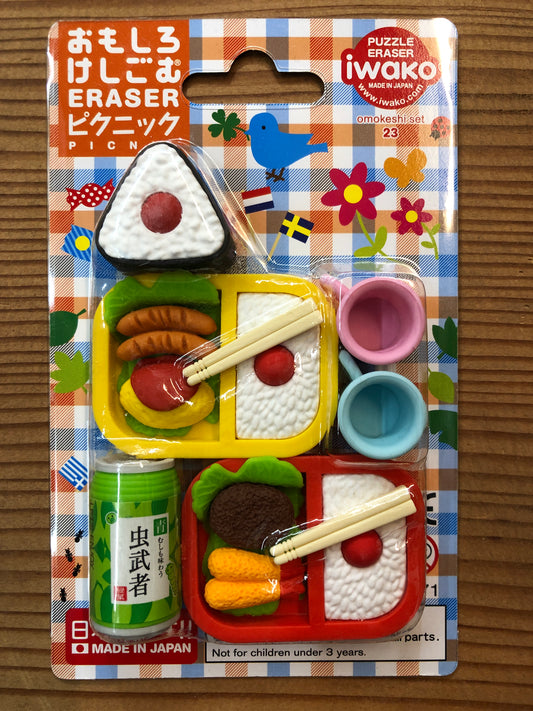 Japanese picnic eraser set with bento boxes, onigiri, soda can, and cups on colorful packaging, made by Iwako