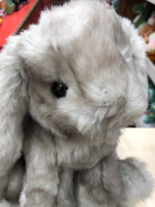 Adorable floppy-eared gray bunny plush toy with soft fur and black eyes, close-up of Licorice sitting bunny's face