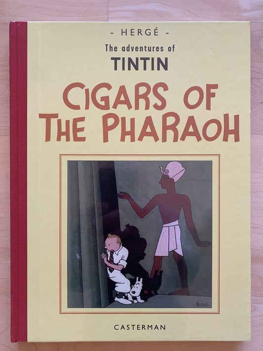 Book cover of Tintin's "Cigars of the Pharaoh" by Hergé, showing Tintin and Snowy hiding from an Egyptian figure, published by Casterman