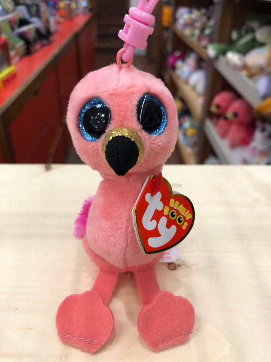 Ty Beanie Boo Gilda pink flamingo plush clip with sparkly blue eyes, black and gold beak, and Ty heart tag, displayed on shelf