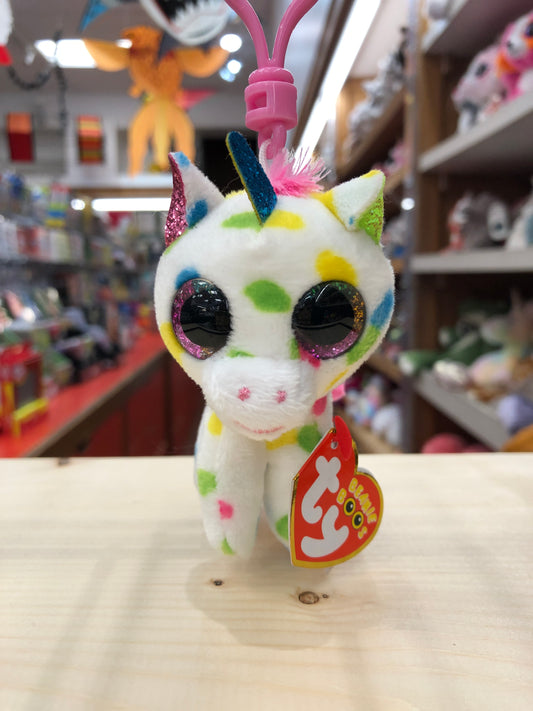Colorful Ty Beanie Boo Harmonie unicorn plush clip with sparkly eyes and multicolored spots, displayed in toy store