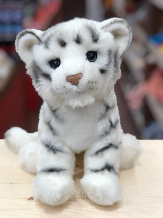 Adorable white tiger cub plush toy with realistic features, soft fur, and airbrushed stripes sitting on wooden surface