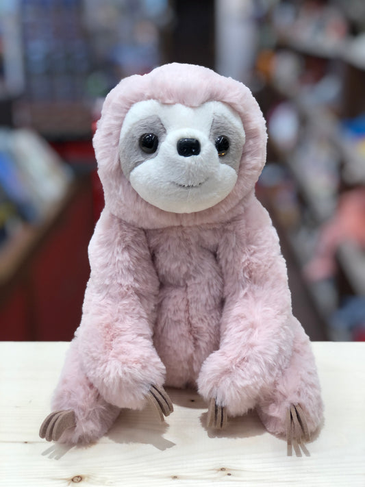 Soft pink sloth plush toy with large eyes and gentle expression, sitting on display with felt claws and stitched smile