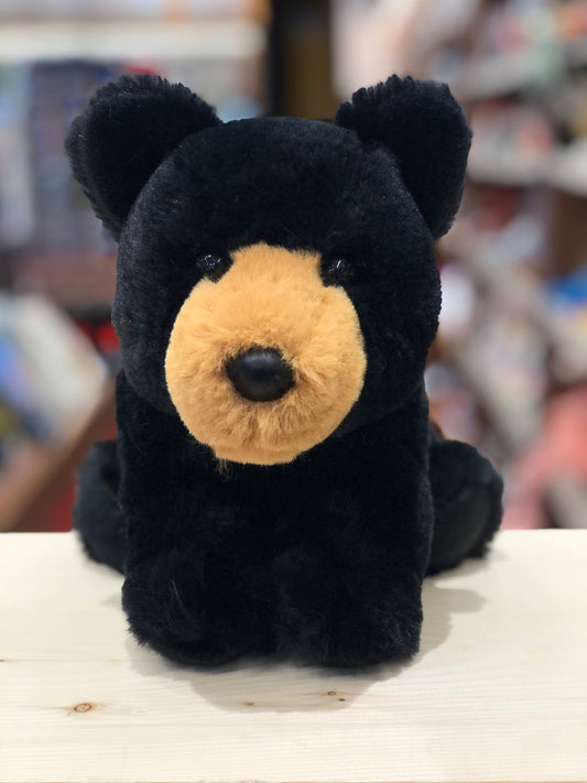 Adorable soft black bear plush toy with tan snout, sitting on display, perfect for cuddling and imaginative play