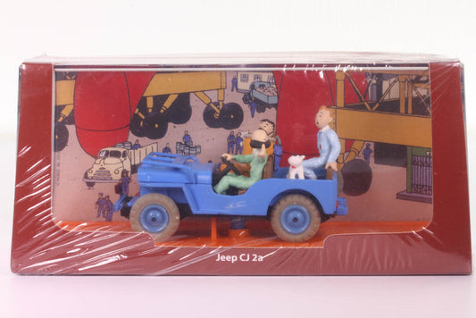 Tintin Jeep CJ2A die-cast model from "Destination Moon" in 1/43 scale, displayed in original box with rocket complex background