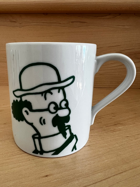 Close-up of a white porcelain Professor Calculus mug resting on a warm wooden surface, featuring a minimalist green line-art illustration of the brilliant, eccentric professor wearing his signature high collar and spectacles, captured in his classic thoughtful pose.