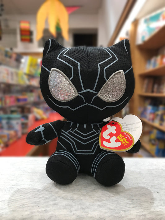 Ty Beanie Baby Black Panther plush toy with sparkly eyes, displayed in bookstore, Marvel collectible for kids and fans