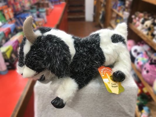 Folkmanis goat puppet with black and white fur, floppy ears, and soft horns displayed in toy store, price tag visible