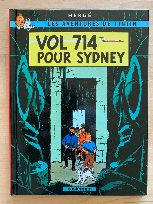 Tintin comic book cover "Vol 714 Pour Sydney" showing characters in a mysterious cave entrance, published by Casterman
