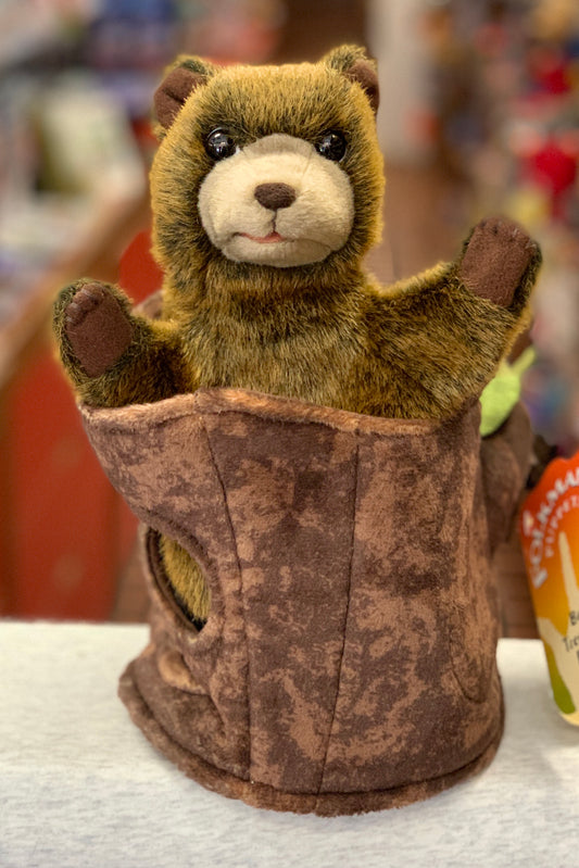Folkmanis Bear in Tree Stump hand puppet with soft fur and movable arms peeking out of a brown tree trunk, perfect for playtime