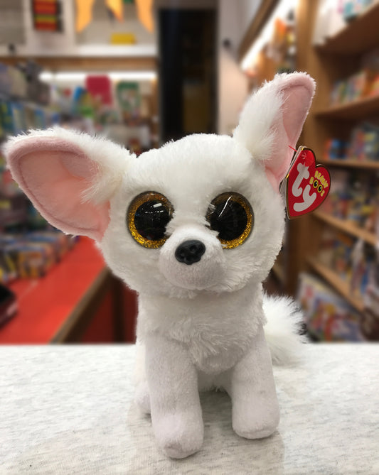 Ty Beanie Boo Phoenix white fox plush with large golden eyes, pink ears, and Ty tag, displayed in toy store