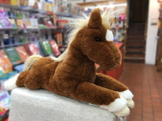 Chestnut horse plush toy with white socks and flaxen mane, displayed in toy store aisle