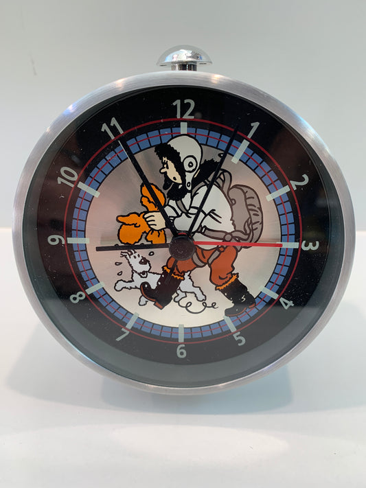 Tintin flight-ready alarm clock with metal construction, showing cartoon character in cold weather gear and parachute