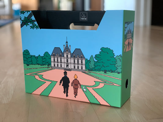 Tintin file box featuring cartoon characters approaching Moulinsart Castle, colorful illustration on sturdy paperboard storage container