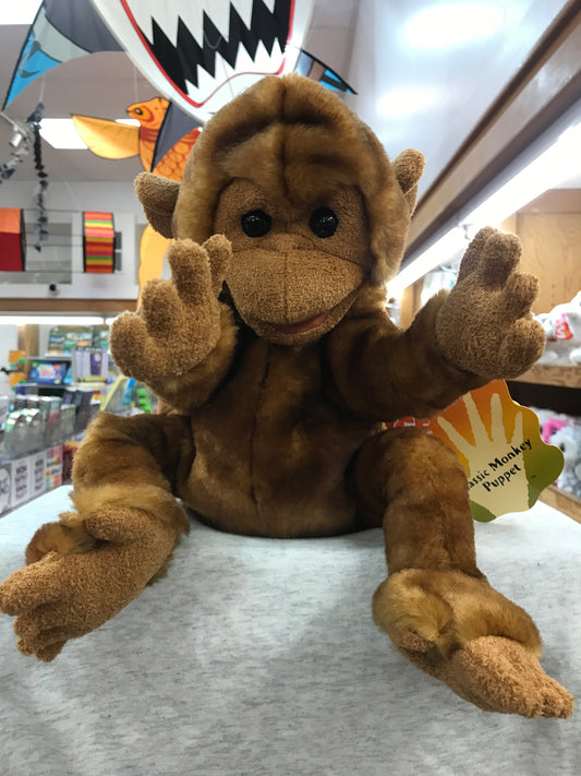 Folkmanis Classic Monkey Puppet, soft brown plush toy with movable arms and expressive face, displayed in toy store