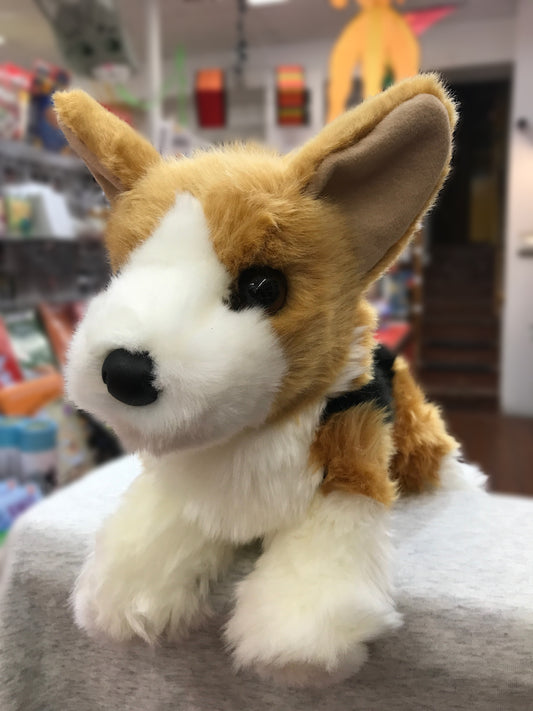 Adorable tri-color Corgi plush toy with large ears and short legs, sitting in a store display with realistic soft fur
