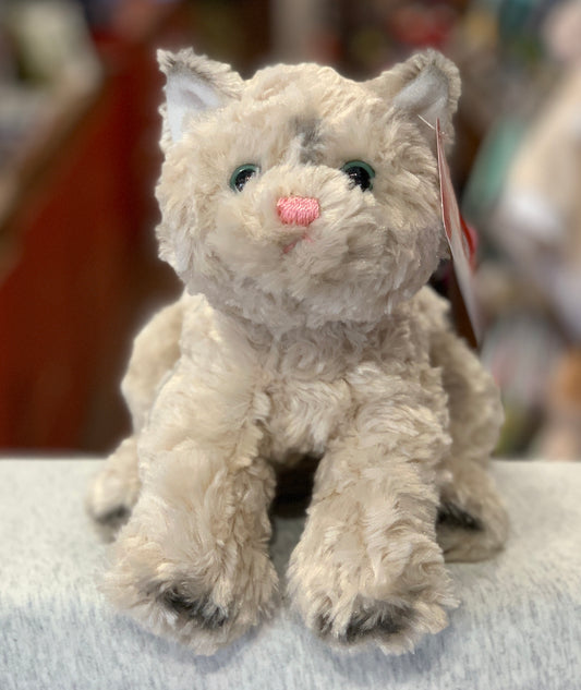 Gund Bootsie tan cat plush toy with fluffy fur, green eyes, and pink nose, sitting on light surface