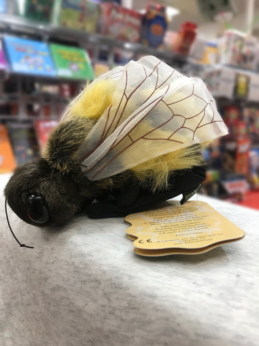 Plush Folkmanis honey bee puppet with detailed wings and fuzzy body, displayed in toy store with product tag