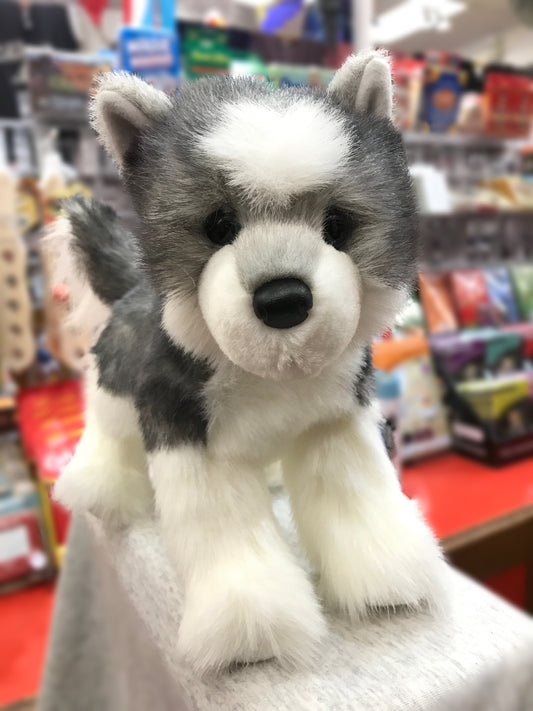 Adorable gray and white husky plush toy with realistic features, sitting on display in a toy store