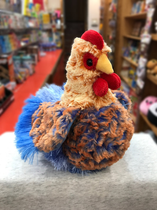 Colorful plush Blue Lace Hen stuffed animal with vibrant red comb and wattle, displayed in toy store setting