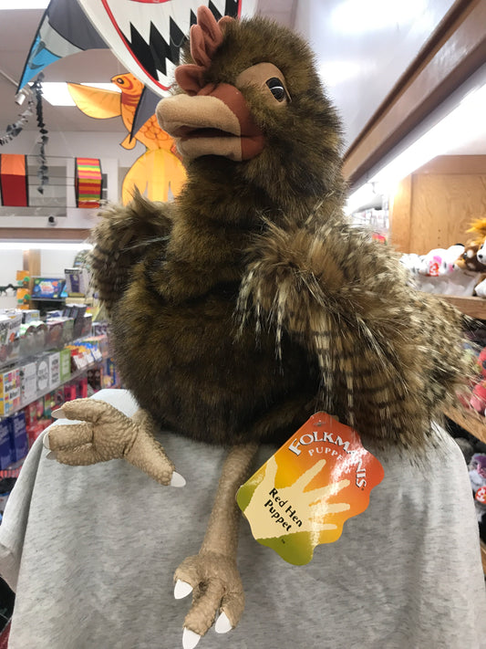 Folkmanis Red Hen Puppet with feathery plush body and movable beak in toy store, perfect for creative storytelling