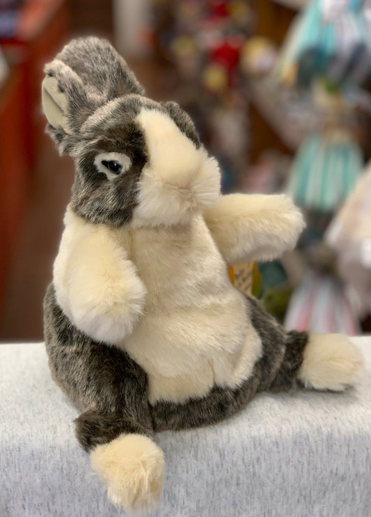 Folkmanis Baby Dutch Rabbit hand puppet with realistic cream and coffee markings, sitting upright on a surface