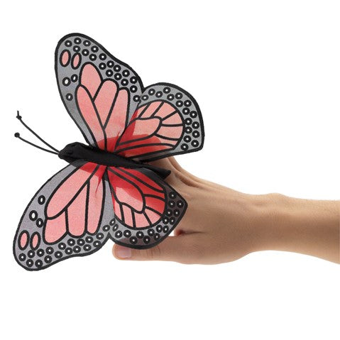 Colorful monarch butterfly finger puppet with sheer wings worn on hand, showcasing realistic orange and black markings