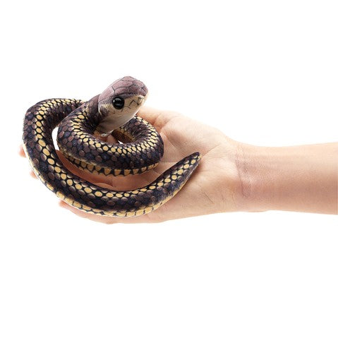 Coiled Folkmanis Mini Snake finger puppet with realistic scales and eyes, held in an open hand for size reference
