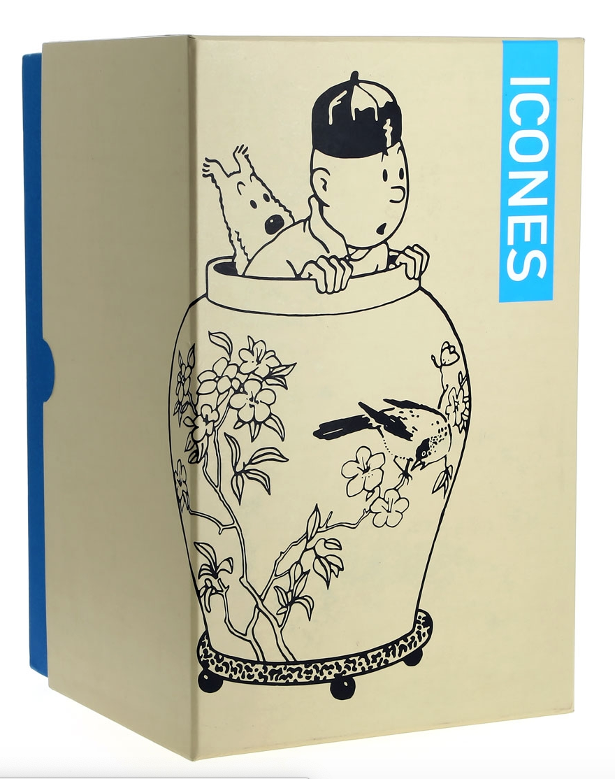 Packaging box for the Tintin The Blue Lotus Vase Icons Collection 22cm resin figurine. The front of the cream-colored box features a large black graphic illustration of Tintin and Snowy peeking out from a decorative Chinese vase adorned with flower branches and a bird, with the bright blue "ICONES" logo running vertically down the right side.