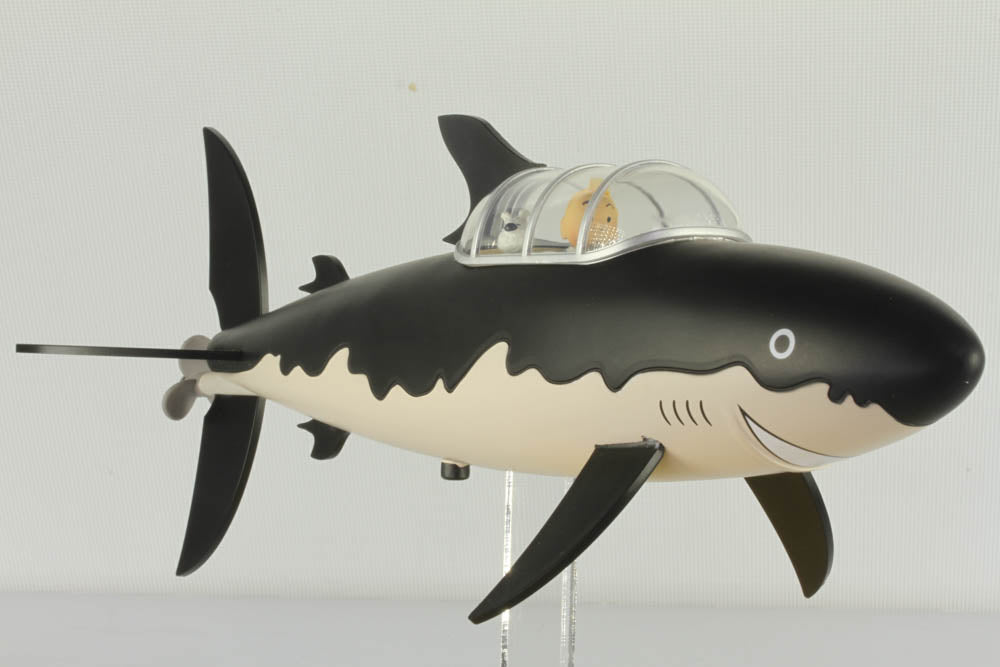 Profile view of the Tintin resin shark submarine model from Red Rackham's Treasure Icons Collection, featuring the black and white shark-shaped vessel with its clear dome cockpit.