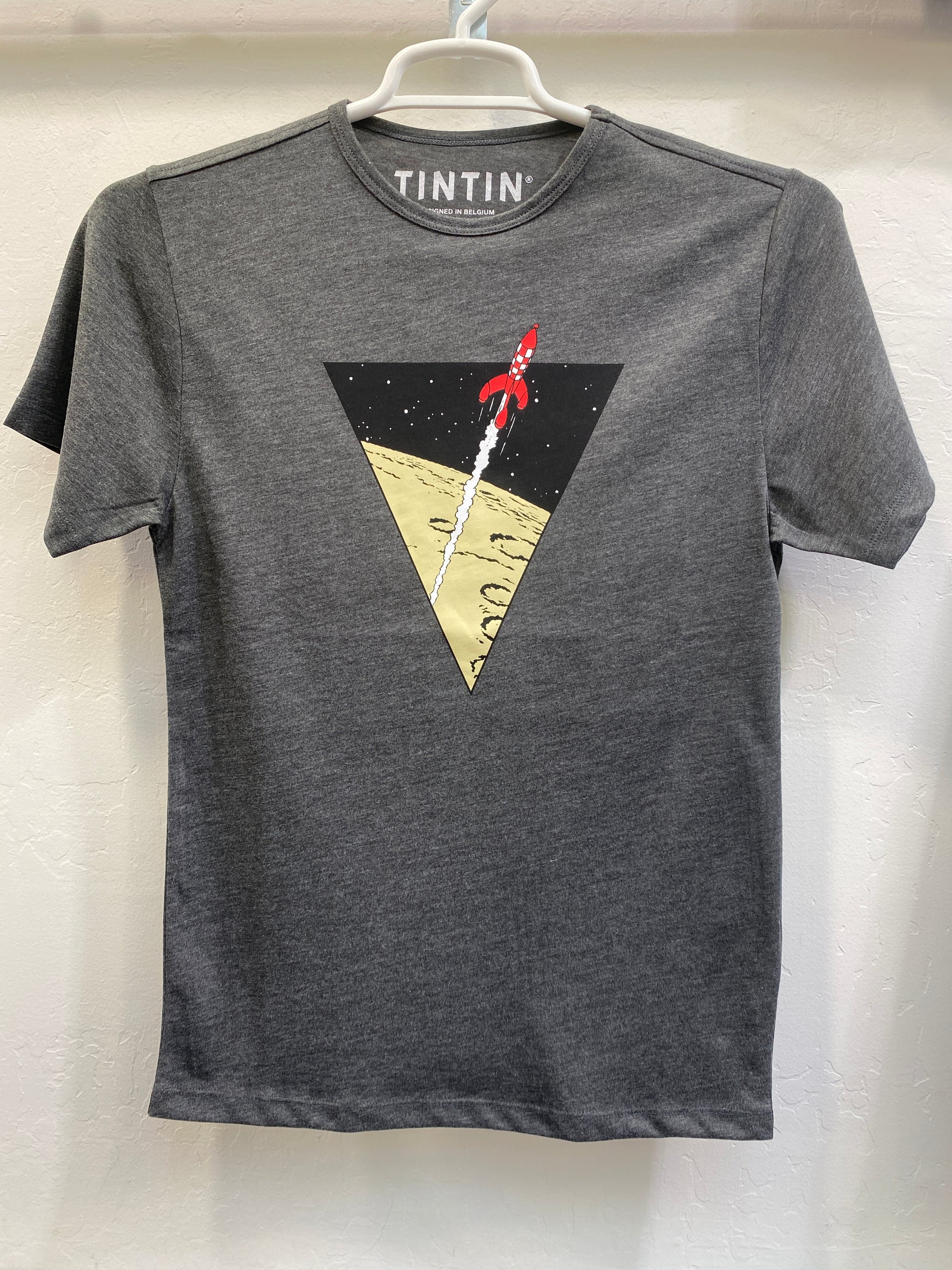 Grey unisex Tintin t-shirt featuring a triangular graphic of the red-and-white Moon Rocket launching from the lunar surface into space.